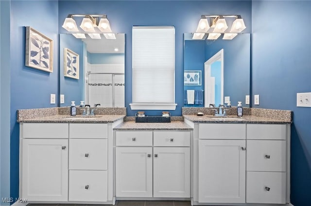 bathroom featuring vanity and a shower with door