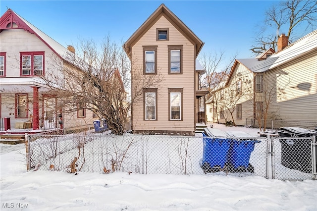 view of snow covered rear of property