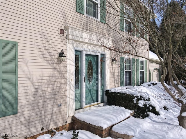 view of snow covered property entrance