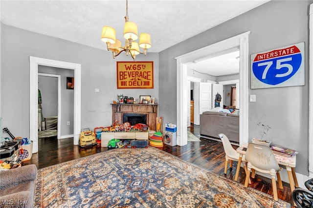 dining area featuring dark wood-type flooring, an inviting chandelier, and a textured ceiling