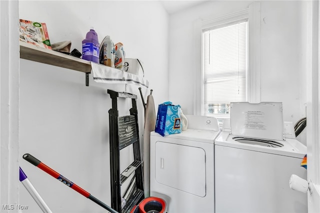 clothes washing area with separate washer and dryer