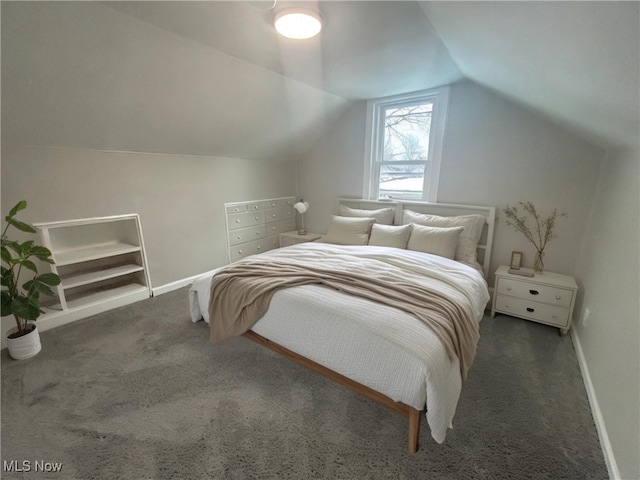 carpeted bedroom with lofted ceiling