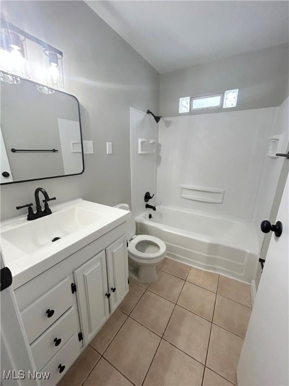 full bathroom with tile patterned floors, toilet,  shower combination, and vanity