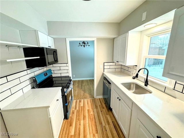 kitchen featuring tasteful backsplash, white cabinetry, sink, dishwashing machine, and stainless steel range with electric cooktop