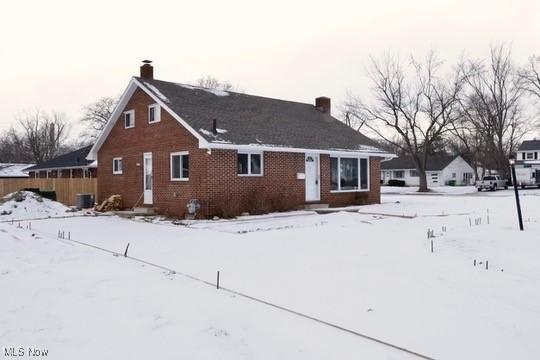 view of snow covered back of property