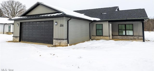 view of snow covered exterior with a garage