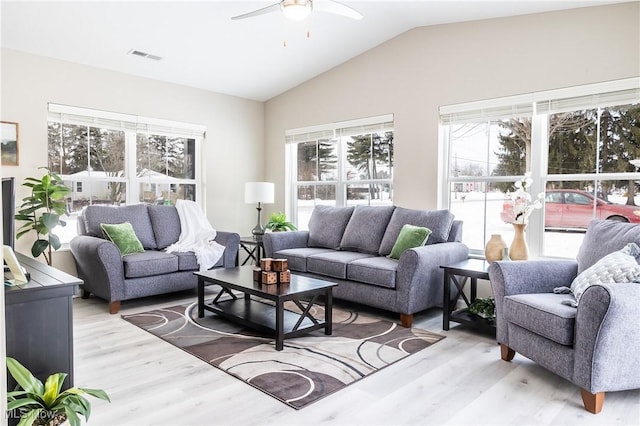 living room featuring vaulted ceiling, ceiling fan, and light wood-type flooring