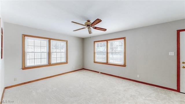 carpeted spare room featuring ceiling fan