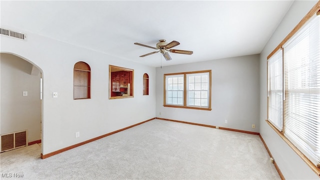 carpeted empty room featuring ceiling fan