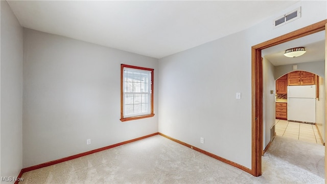 spare room with light colored carpet