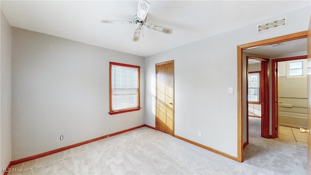 unfurnished bedroom with light carpet and ceiling fan