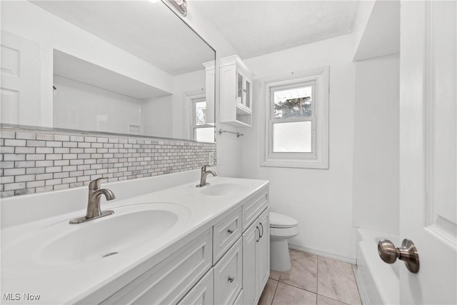 bathroom featuring decorative backsplash, vanity, tile patterned floors, and toilet