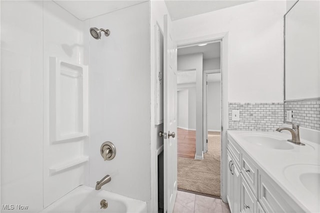 bathroom featuring tasteful backsplash, shower / tub combination, and vanity