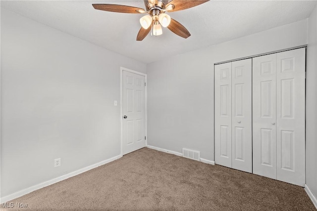 unfurnished bedroom featuring a closet, ceiling fan, and carpet flooring