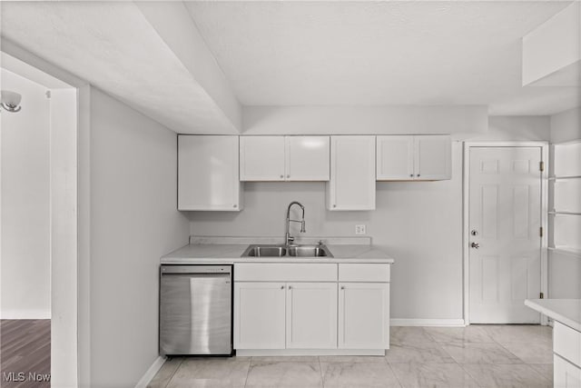 kitchen featuring white cabinetry, dishwasher, and sink