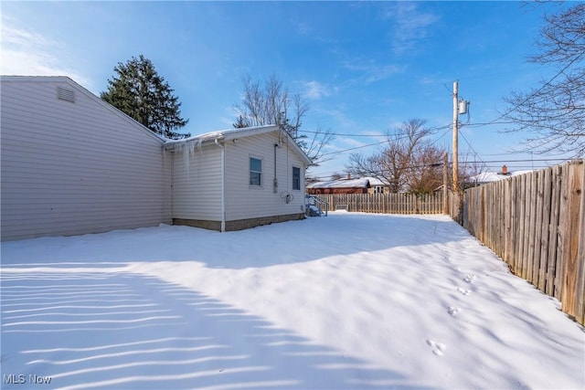 view of yard layered in snow