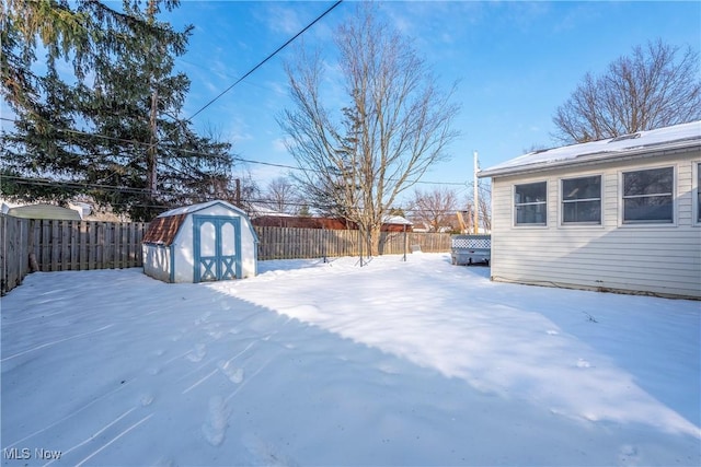 snowy yard with a shed