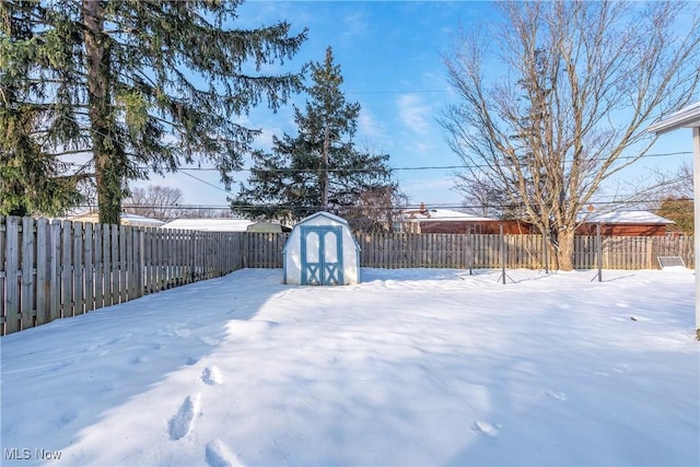 snowy yard with a shed