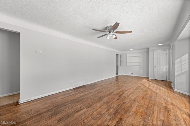 unfurnished living room featuring hardwood / wood-style floors, a textured ceiling, and ceiling fan