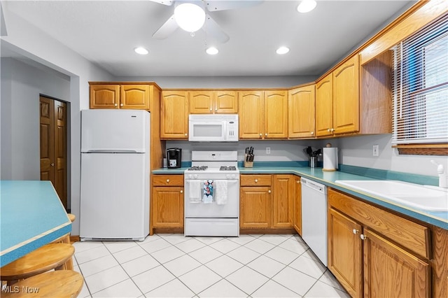 kitchen with sink, white appliances, light tile patterned floors, and ceiling fan