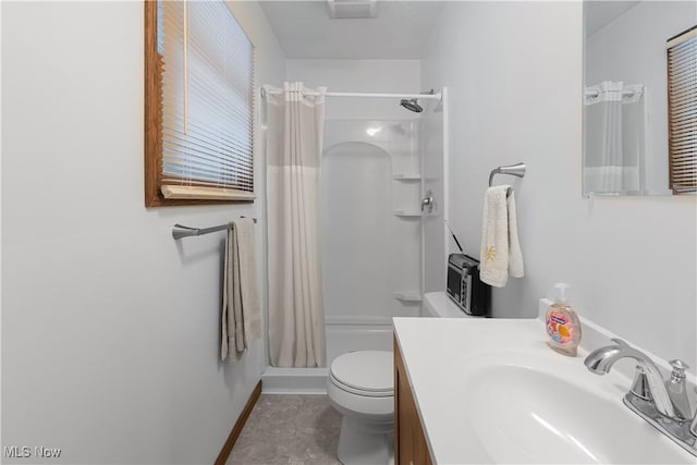 bathroom featuring vanity, toilet, and a shower with shower curtain