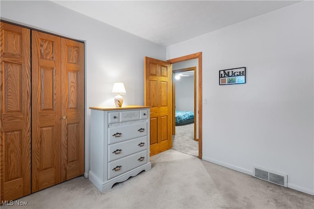 bedroom featuring a closet and light carpet