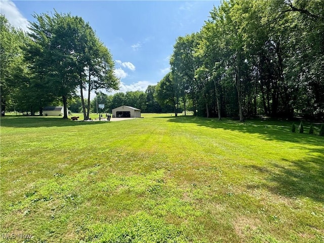 3438 Warren Meadville Rd, Cortland, OH 44410 - view of green lawn with an outdoor structure and a pole building
