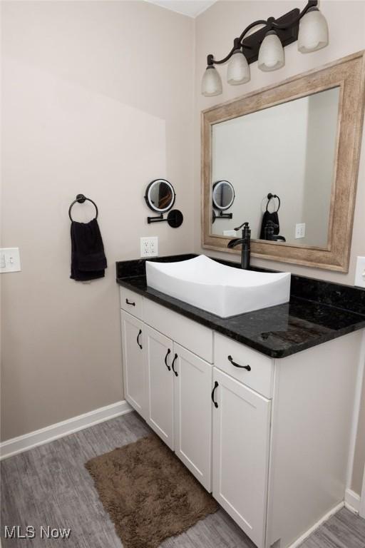 bathroom featuring hardwood / wood-style flooring and vanity