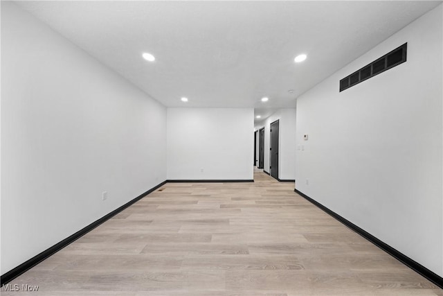 spare room featuring light wood-type flooring