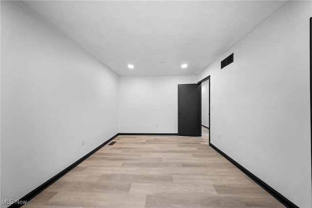 unfurnished room featuring light hardwood / wood-style floors