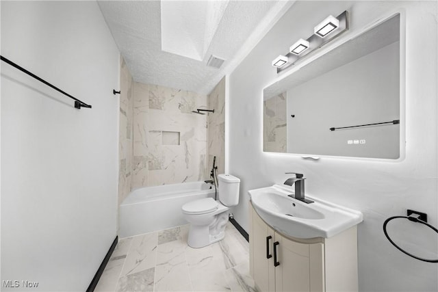 full bathroom featuring tiled shower / bath, vanity, toilet, and a textured ceiling