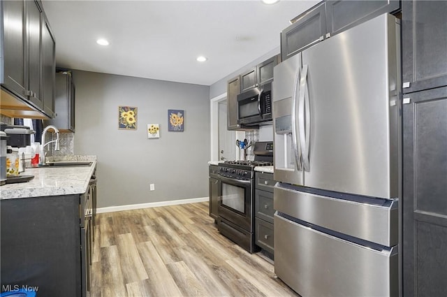 kitchen featuring sink, light hardwood / wood-style flooring, and stainless steel appliances