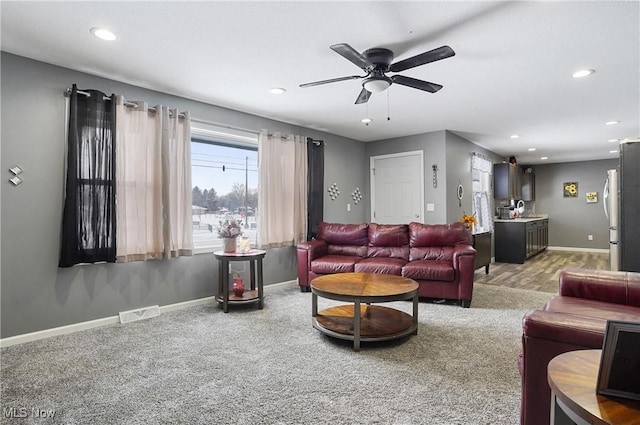 living room featuring ceiling fan and carpet floors