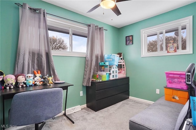 office space featuring light colored carpet and ceiling fan