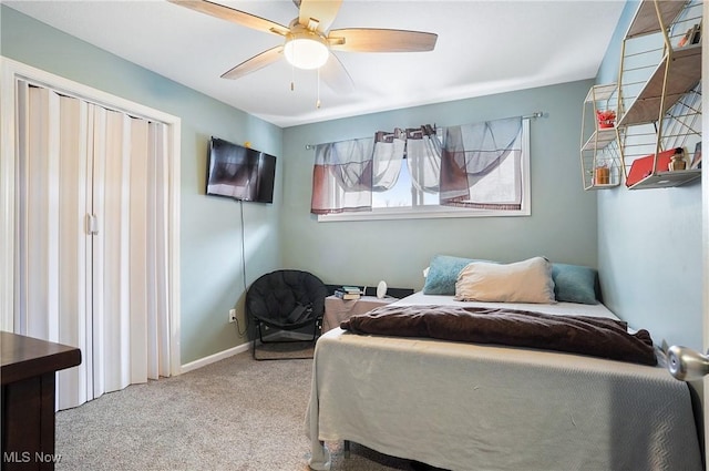 bedroom featuring ceiling fan and light carpet