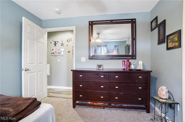 bedroom featuring ceiling fan and light carpet