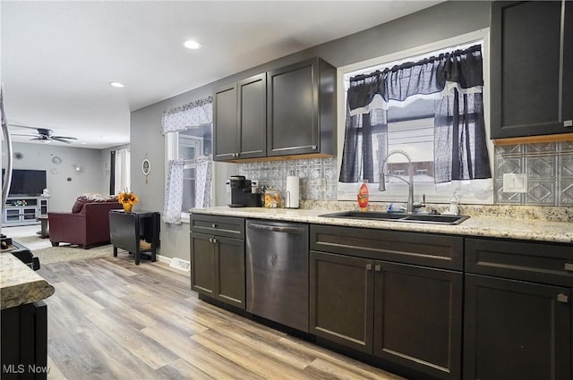 kitchen featuring dishwasher, sink, backsplash, and light hardwood / wood-style floors