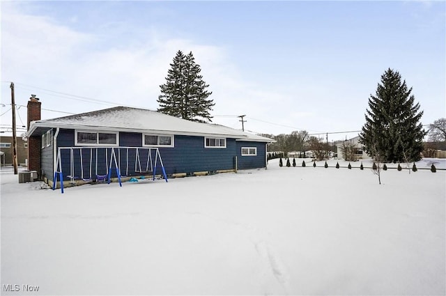 snow covered house with cooling unit