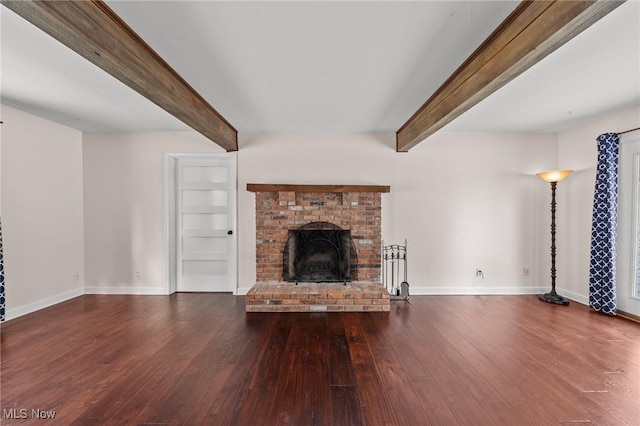 unfurnished living room with a brick fireplace, dark hardwood / wood-style floors, and beam ceiling