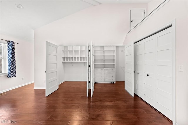 interior space featuring lofted ceiling with beams and dark hardwood / wood-style floors