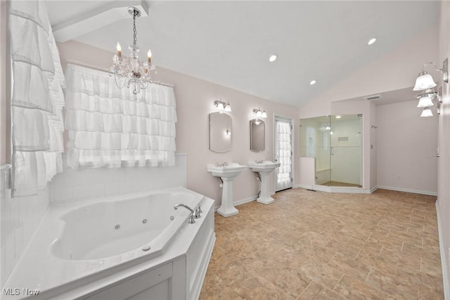 bathroom featuring sink, vaulted ceiling, and plus walk in shower