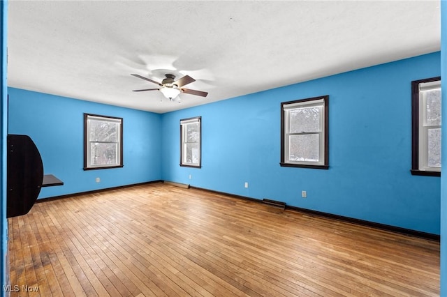 empty room featuring light hardwood / wood-style flooring and ceiling fan