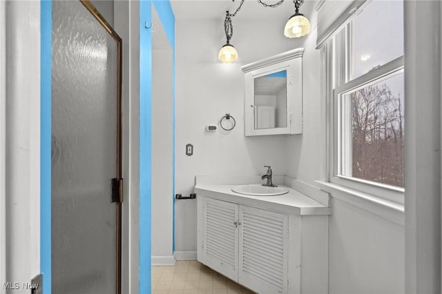 bathroom featuring vanity and a shower with door