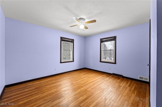 empty room featuring ceiling fan and hardwood / wood-style floors