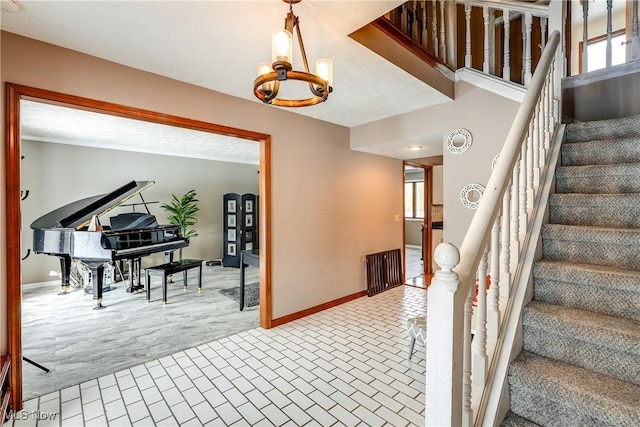 staircase featuring an inviting chandelier