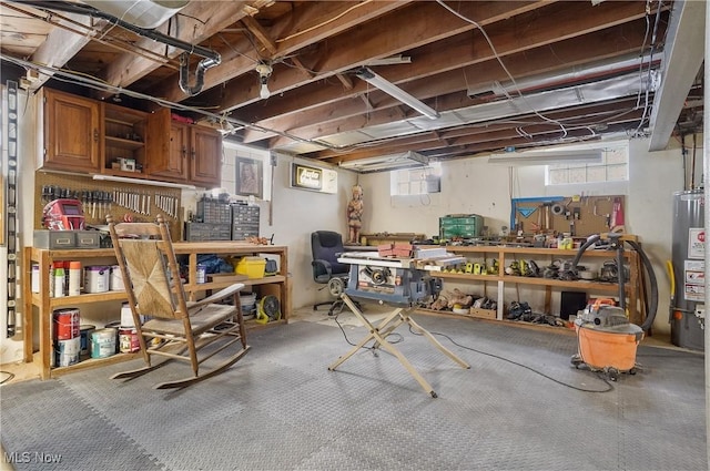 basement with water heater and a workshop area