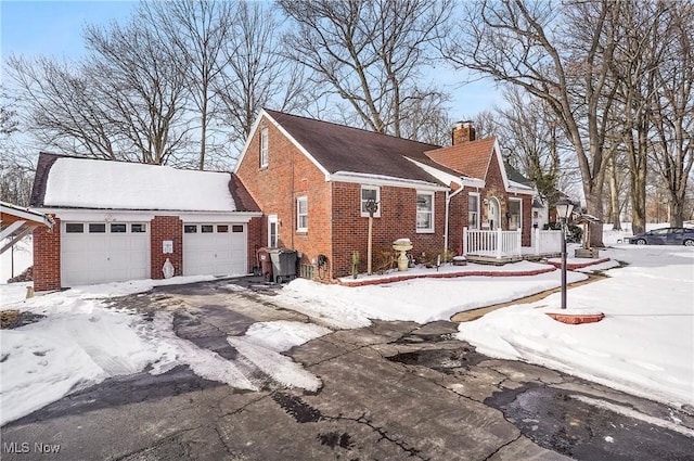 view of snowy exterior with a garage