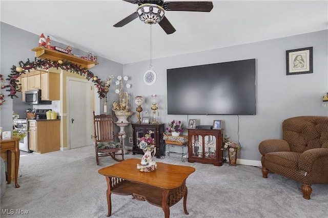 living room featuring light colored carpet and ceiling fan