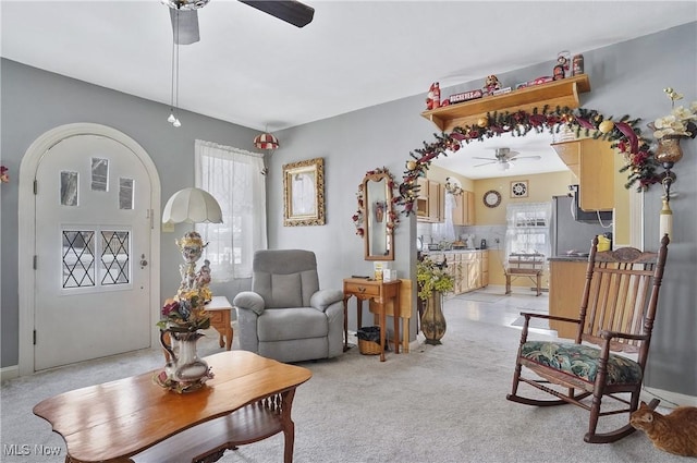 carpeted living room with ceiling fan