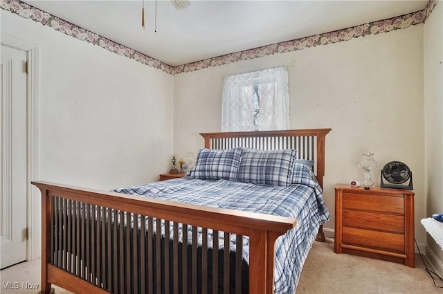 bedroom featuring light carpet